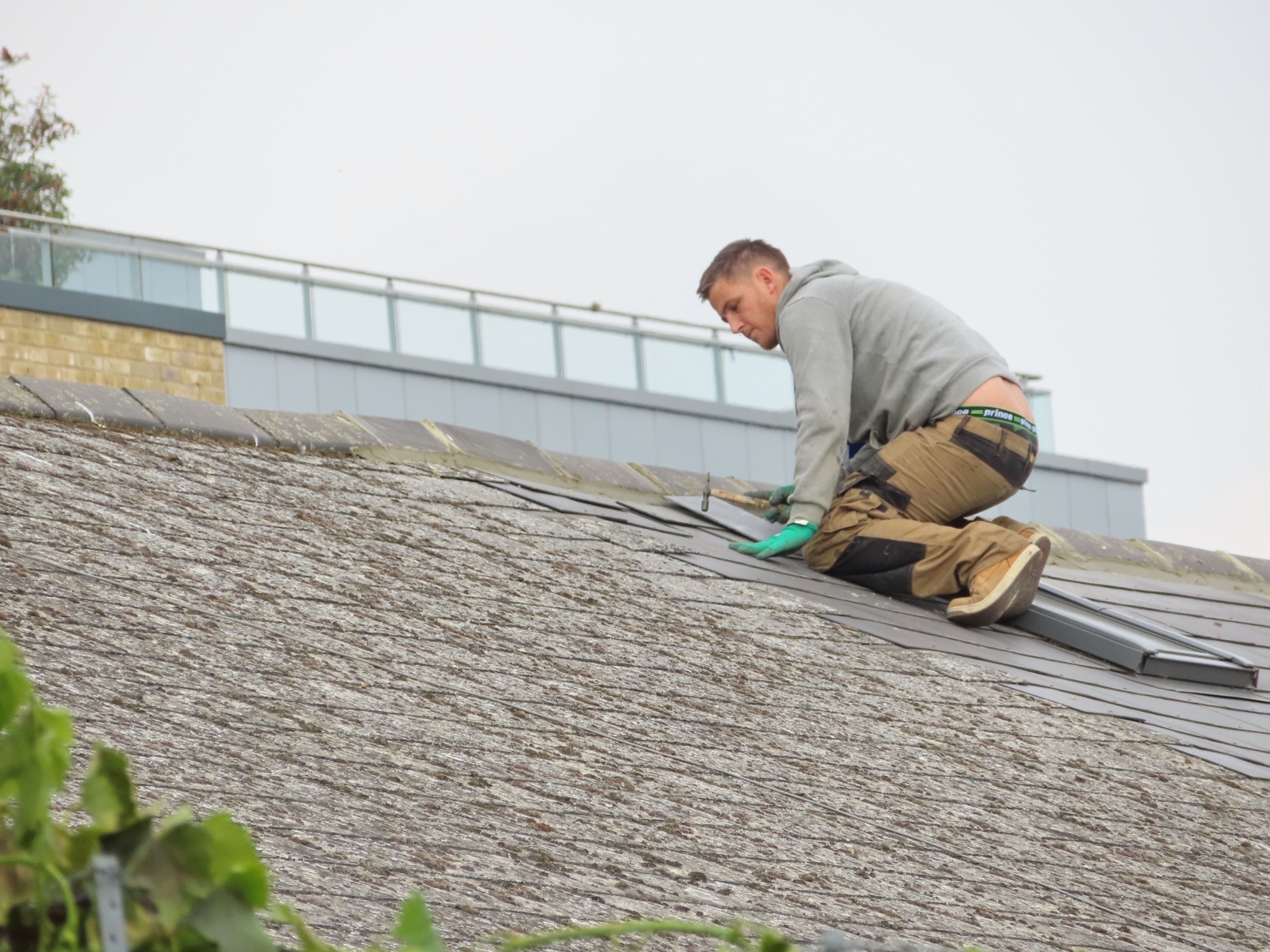 Chester County roofing contractor installing slate tiles on a residential roof